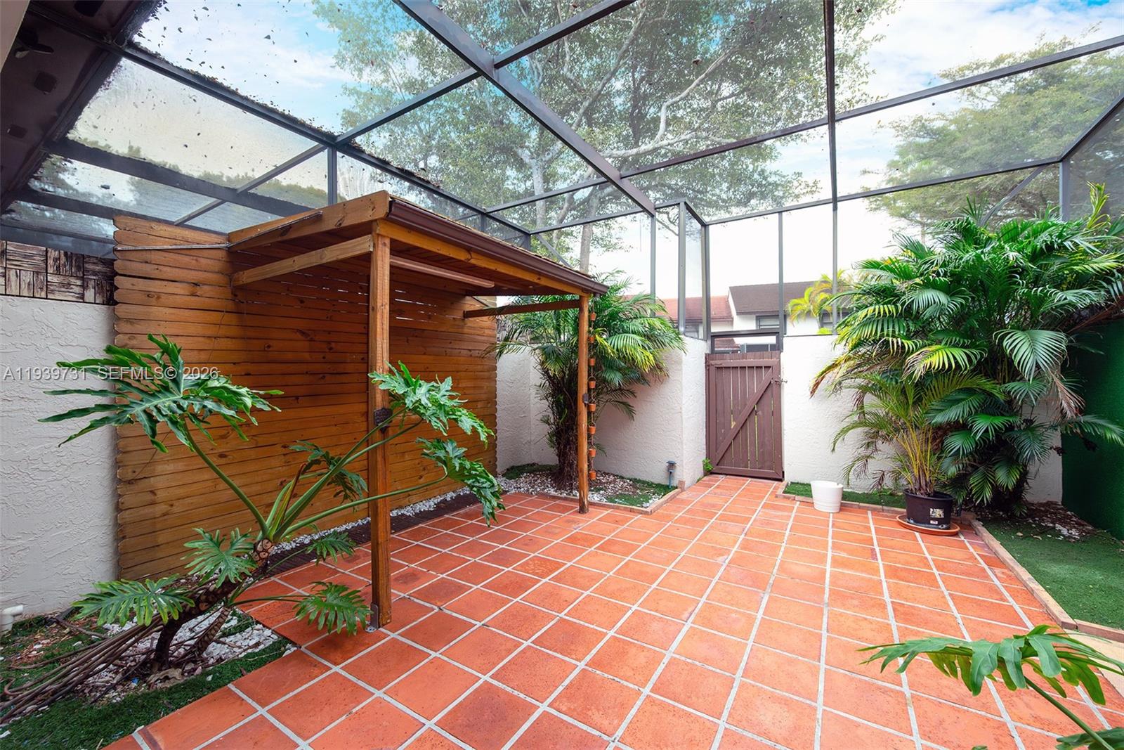 9079 Southwest 133rd Court, Unit F Miami, FL 33186 - Photo 16 of 34 a view of a backyard