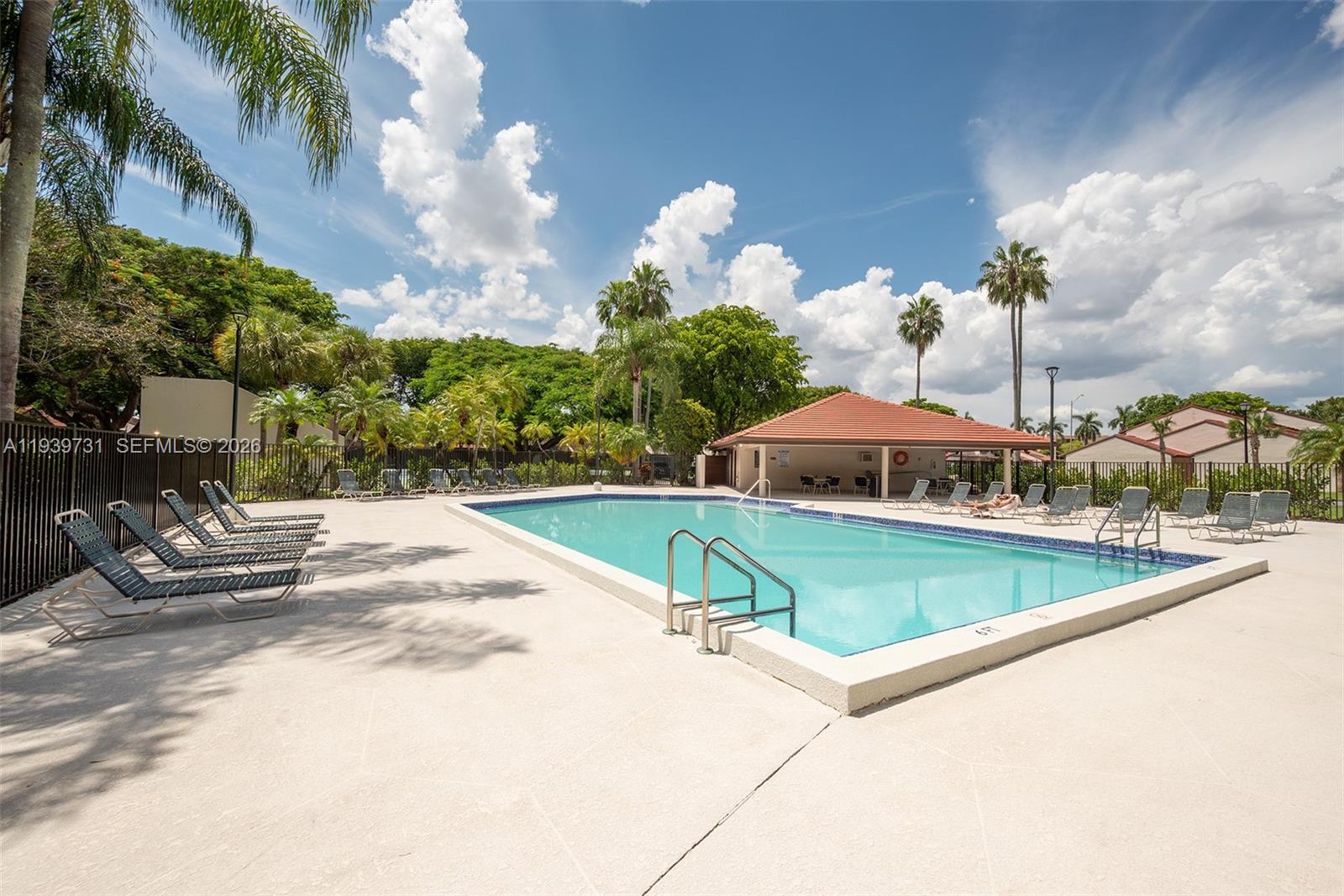 9079 Southwest 133rd Court, Unit F Miami, FL 33186 - Photo 33 of 34 a view of a swimming pool with a patio