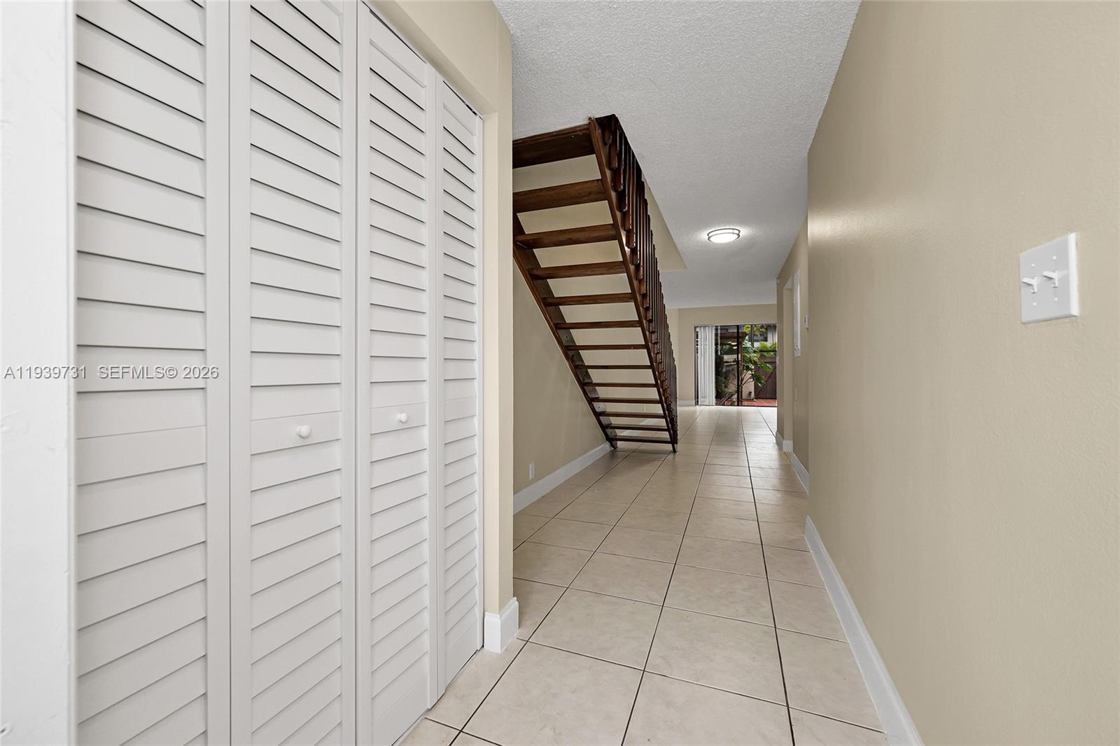 9079 Southwest 133rd Court, Unit F Miami, FL 33186 - Photo 5 of 34 a view of entryway and hall with wooden floor
