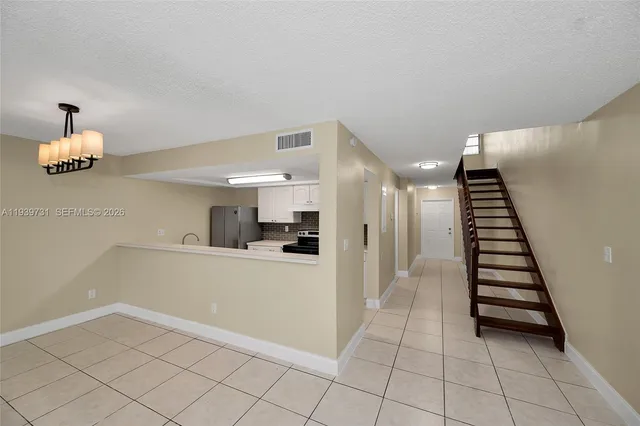 a view of a kitchen with wooden floor and electronic appliances