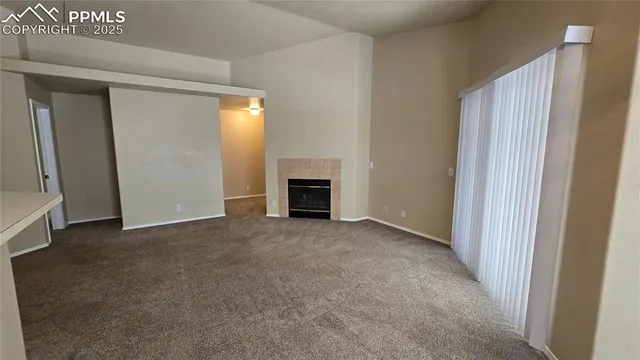 a view of empty room with a fireplace
