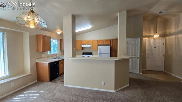 a kitchen with a sink and refrigerator