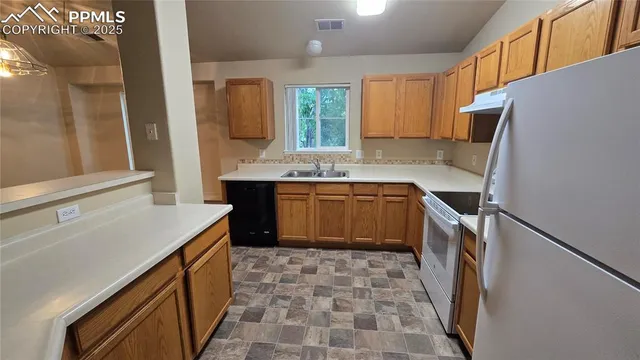 a kitchen with a sink stove and cabinets