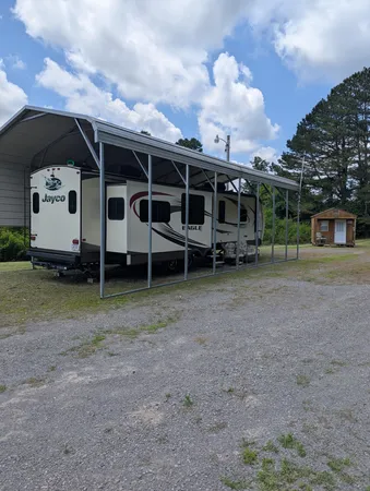 a view of a house with a yard and wooden fence
