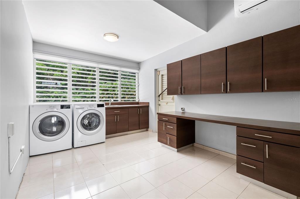 1 Street, Unit 606 Guaynabo, PR 00966 - Photo 16 of 32 a kitchen with a stove top oven sink and cabinets