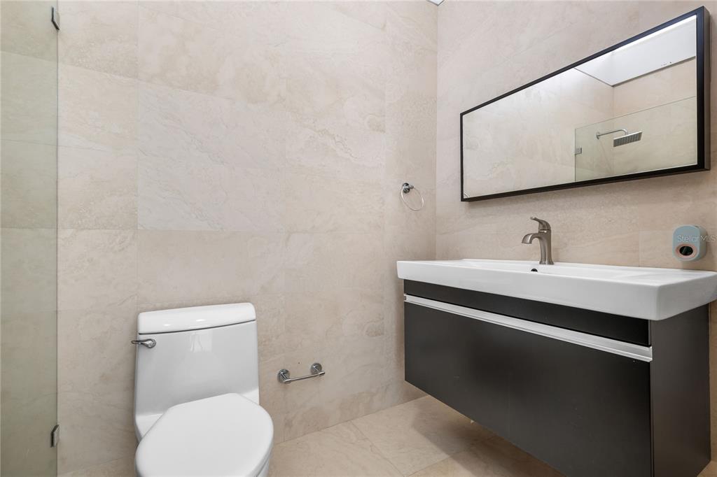 1 Street, Unit 606 Guaynabo, PR 00966 - Photo 21 of 32 a bathroom with a toilet sink and mirror