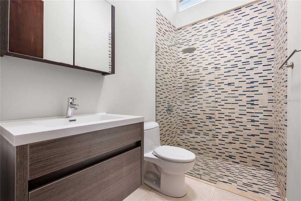 1 Street, Unit 606 Guaynabo, PR 00966 - Photo 23 of 32 a bathroom with a sink a toilet and mirror