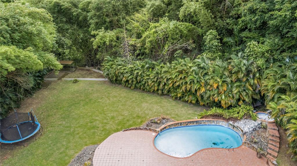1 Street, Unit 606 Guaynabo, PR 00966 - Photo 31 of 32 a backyard of a house with a yard and outdoor seating