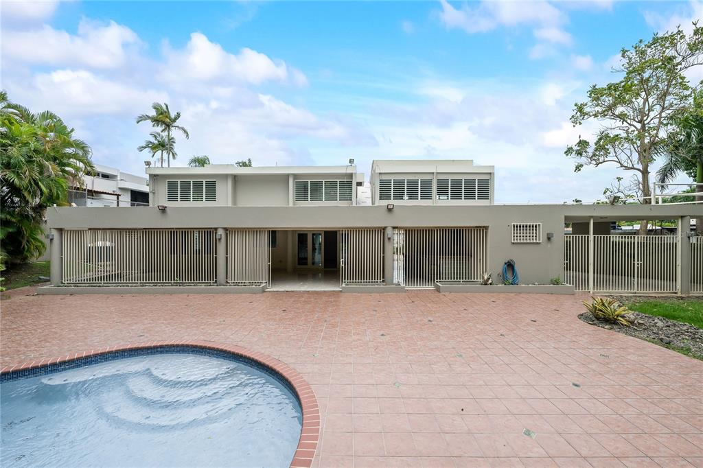 1 Street, Unit 606 Guaynabo, PR 00966 - Photo 5 of 32 a front view of a house with a garden and yard