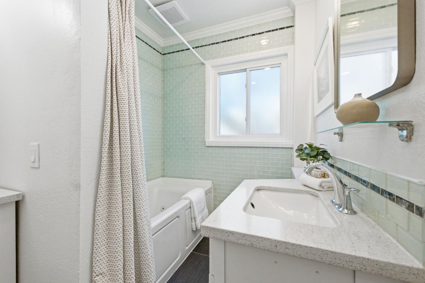 9858 Golf Links Road Oakland, CA 94605 - Photo 24 of 39 a bathroom with a sink and a mirror