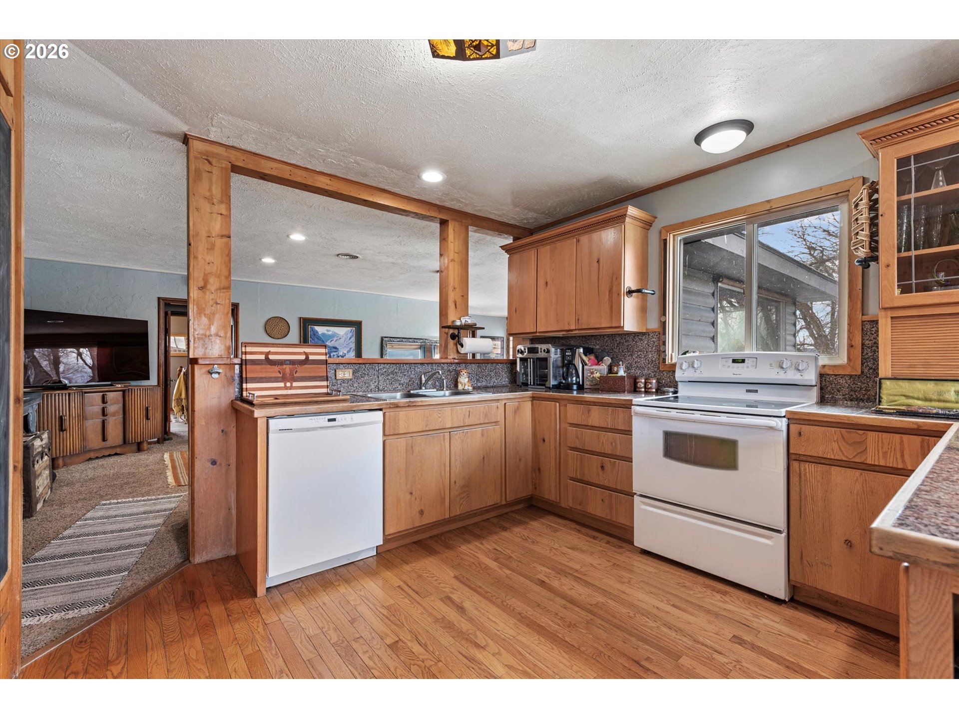 46278 Pocahontas Road Haines, OR 97833 - Photo 19 of 42 a kitchen with white cabinets and white appliances