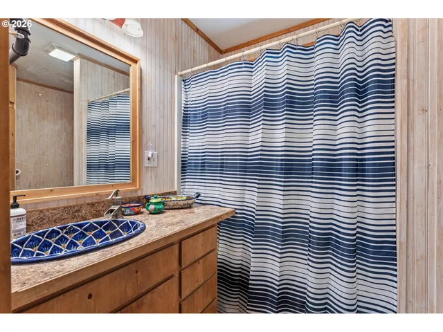 a view of a bathroom with a shower and a mirror