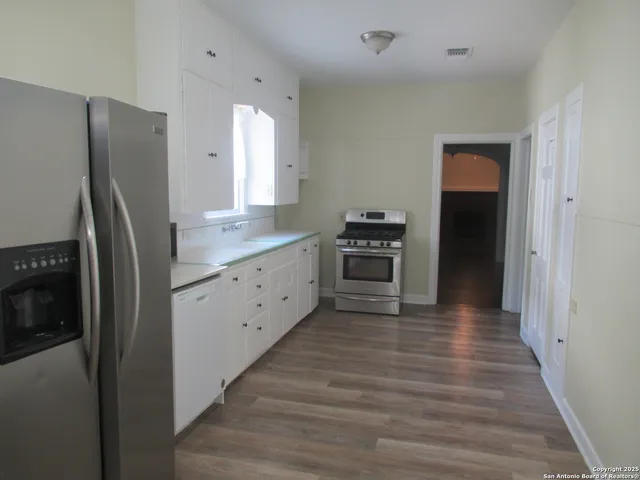 a kitchen with stainless steel appliances a refrigerator and a stove