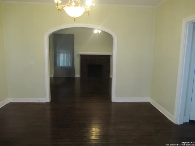 a view of a livingroom with wooden floor and a staircase