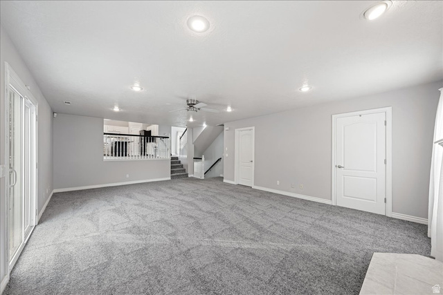 7 Reflection Way St. George, UT 84770 - Photo 22 of 54 Unfurnished living room with light carpet, stairway, recessed lighting, and ceiling fan