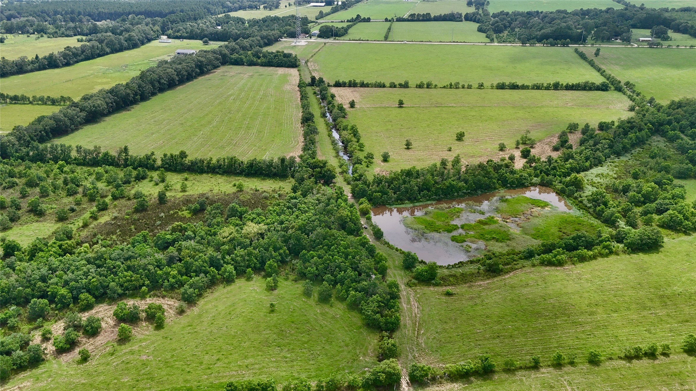 31100 Old Sour Lake Road Sour Lake, TX 77659 - Photo 16 of 32 a view of a lake with a yard and large trees