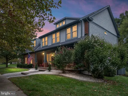 a view of a house with a yard porch and sitting area