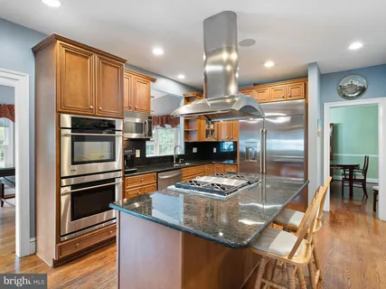 a kitchen with stainless steel appliances granite countertop a stove and a sink
