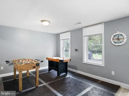 a bathroom with a sink a toilet a mirror and shower curtain