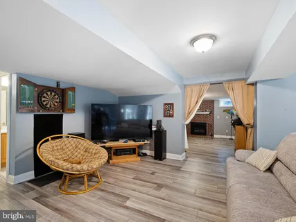 a view of a house with a big yard and large trees