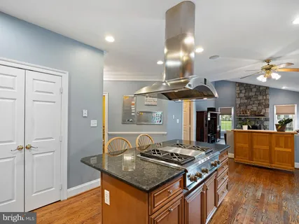 a kitchen with stainless steel appliances granite countertop a stove and a sink