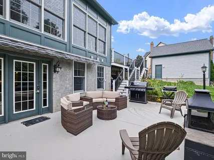 a backyard of a house with outdoor seating