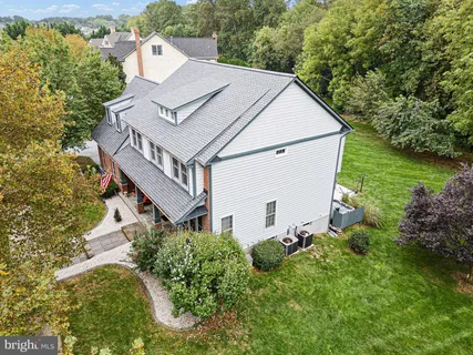 an aerial view of a house with a yard basket ball court and outdoor seating