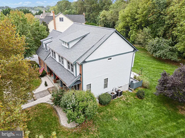 an aerial view of a house with a yard basket ball court and outdoor seating