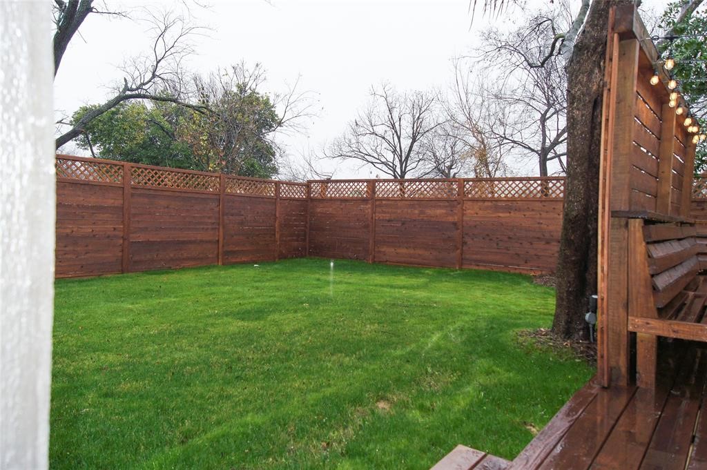 1727 Pueblo Street Dallas, TX 75212 - Photo 25 of 27 a view of backyard with wooden fence and a bench
