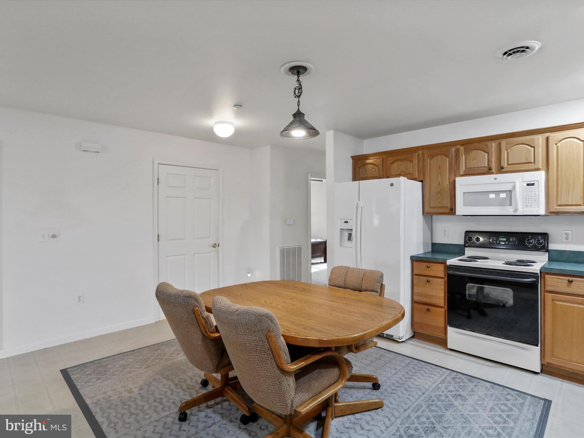 324 Key W Drive Hagerstown, MD 21740 - Photo 11 of 28 a living room with stainless steel appliances furniture a dining table and a fireplace