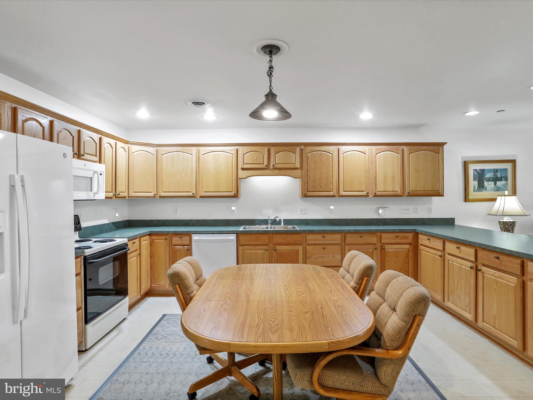 324 Key W Drive Hagerstown, MD 21740 - Photo 9 of 28 a kitchen with stainless steel appliances granite countertop a sink a stove a refrigerator cabinets and chairs