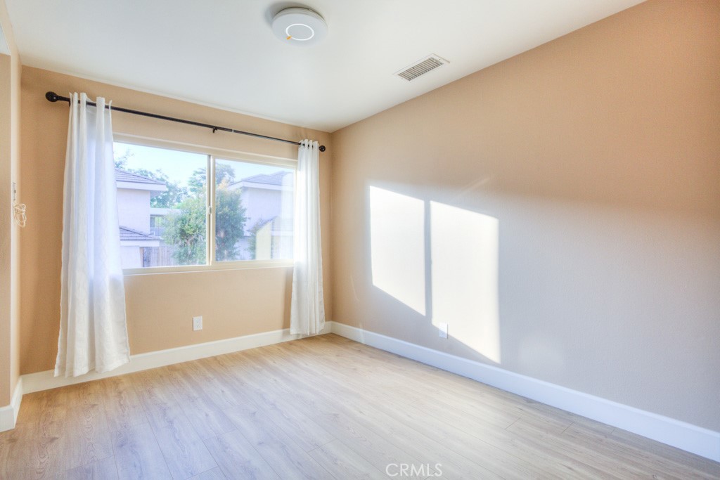 313 South Almansor Street, Unit 2 Alhambra, CA 91801 - Photo 13 of 39 an empty room with wooden floor and windows