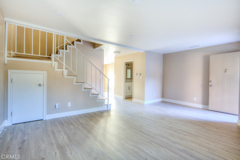 313 South Almansor Street, Unit 2 Alhambra, CA 91801 - Photo 9 of 39 a view of a hallway with wooden floor and stairs
