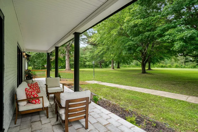 a dining room with furniture window and wooden floor