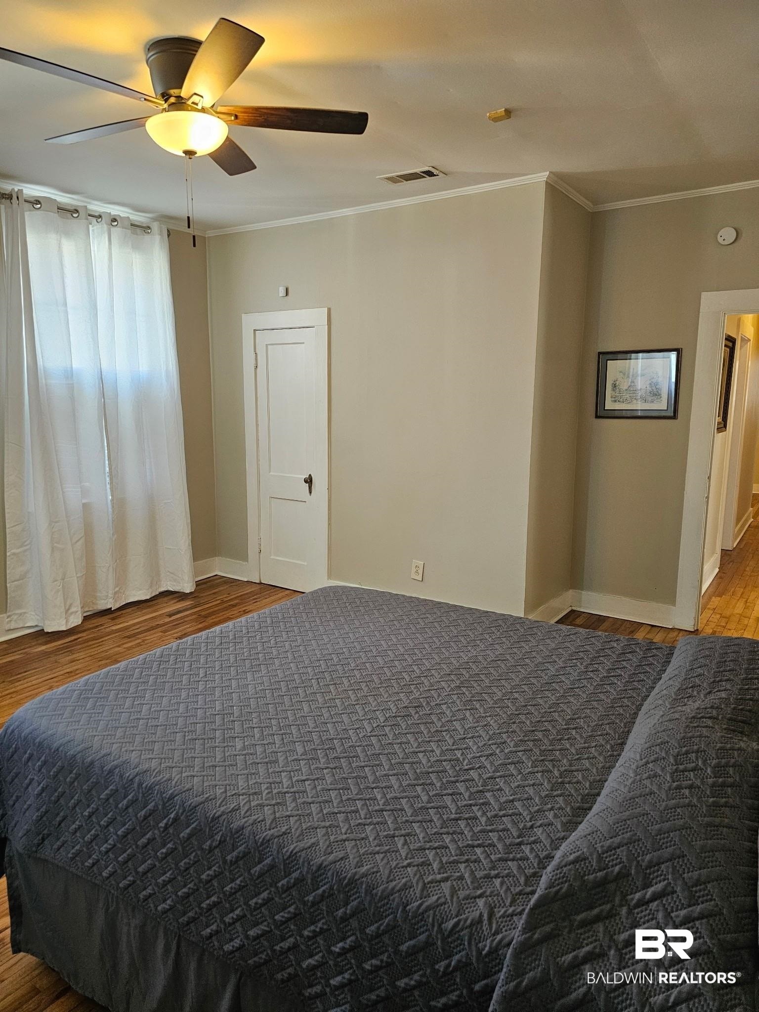 1215 Church Street Mobile, AL 36604 - Photo 15 of 23 Bedroom featuring crown molding, visible vents, a ceiling fan, wood finished floors, and baseboards