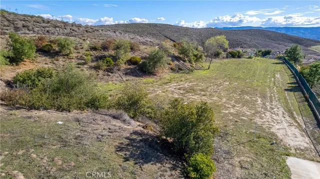 a view of a yard with mountains in the background