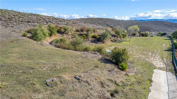 a view of a big yard with mountains in the background