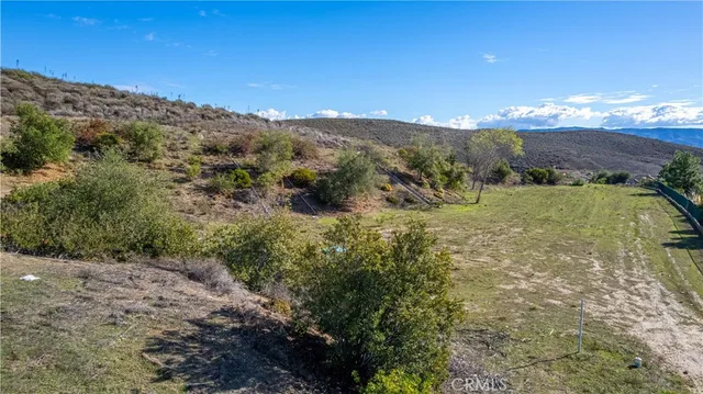 a view of a large building with mountains in the background