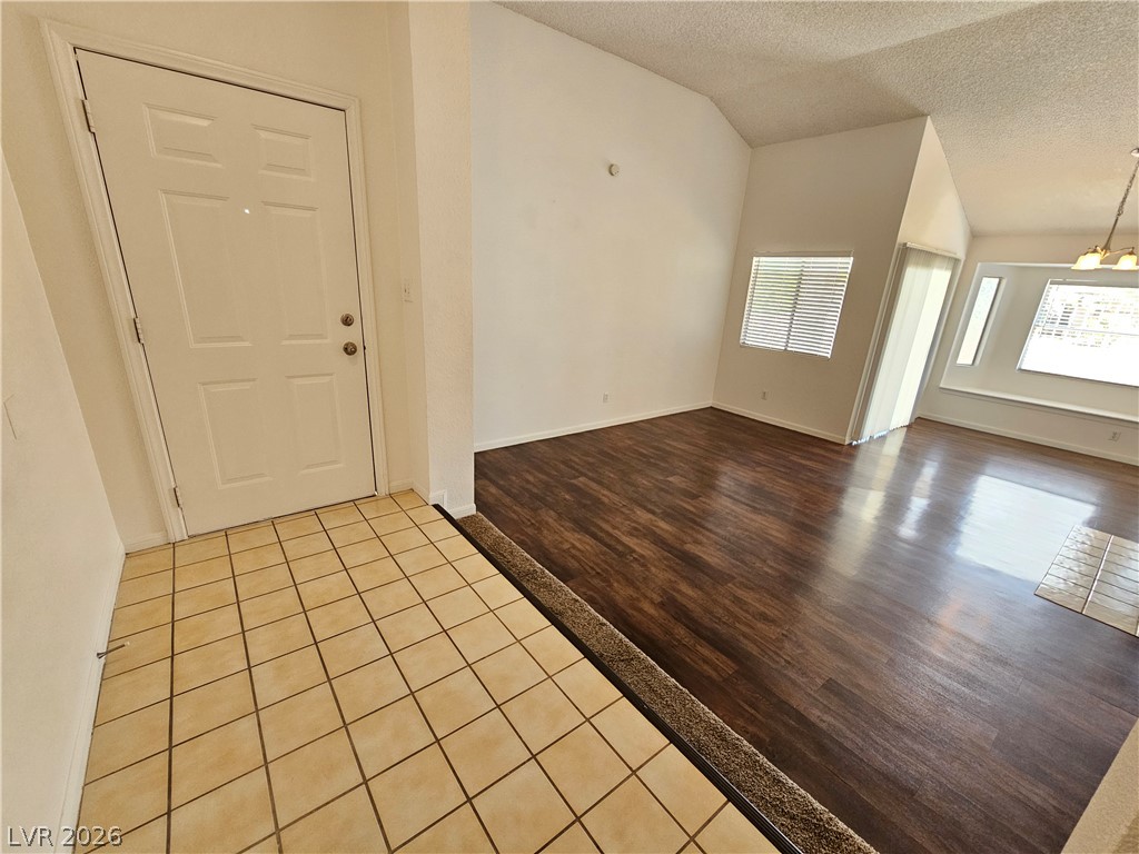 2817 Albemarle Way Henderson, NV 89014 - Photo 7 of 25 Step into a luminous interior featuring vaulted ceilings and polished hardwood flooring.
