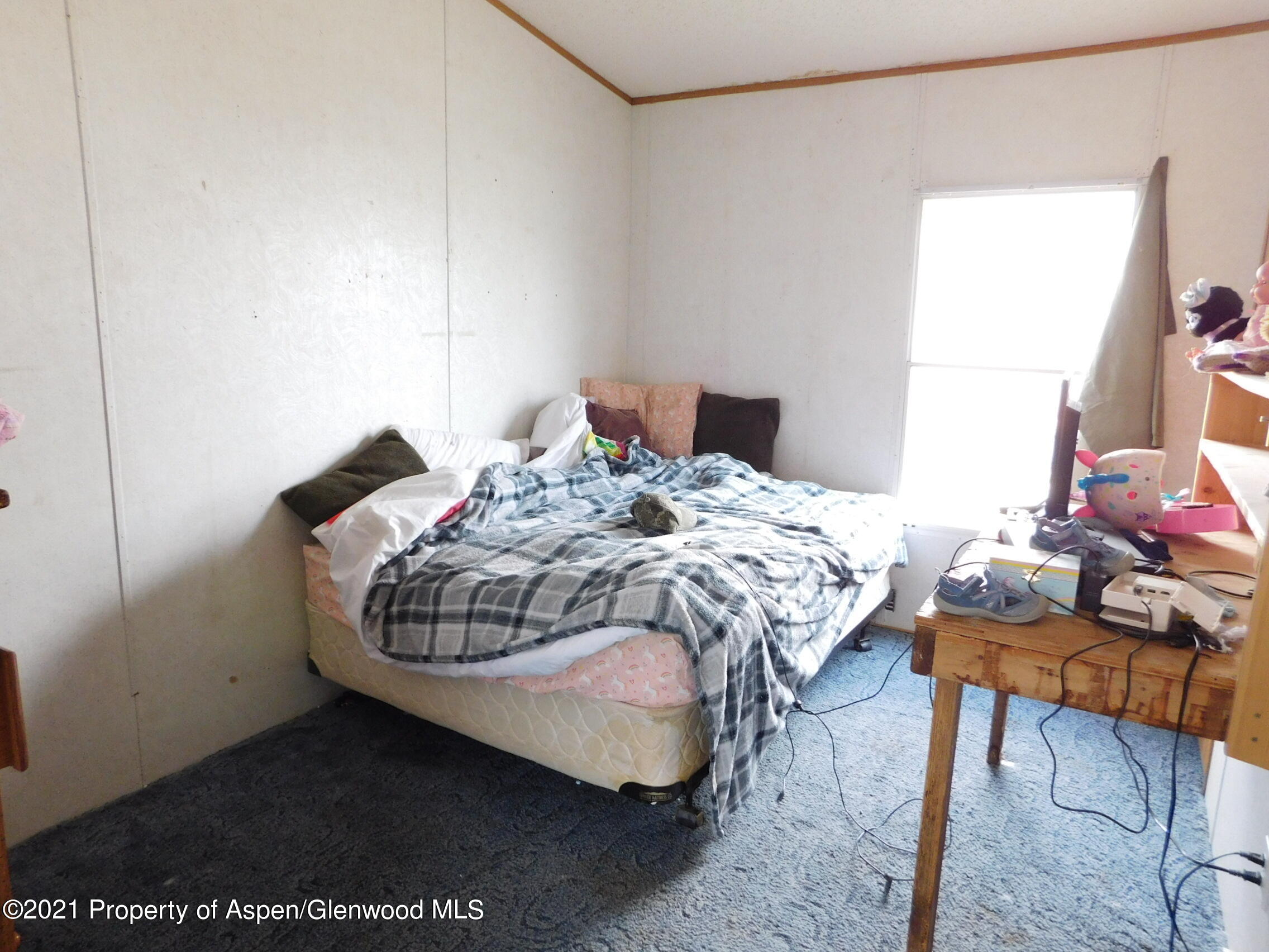 2210 West 3rd Street, Unit 28 Craig, CO 81625 - Photo 12 of 12 a bedroom with a bed and a table in it