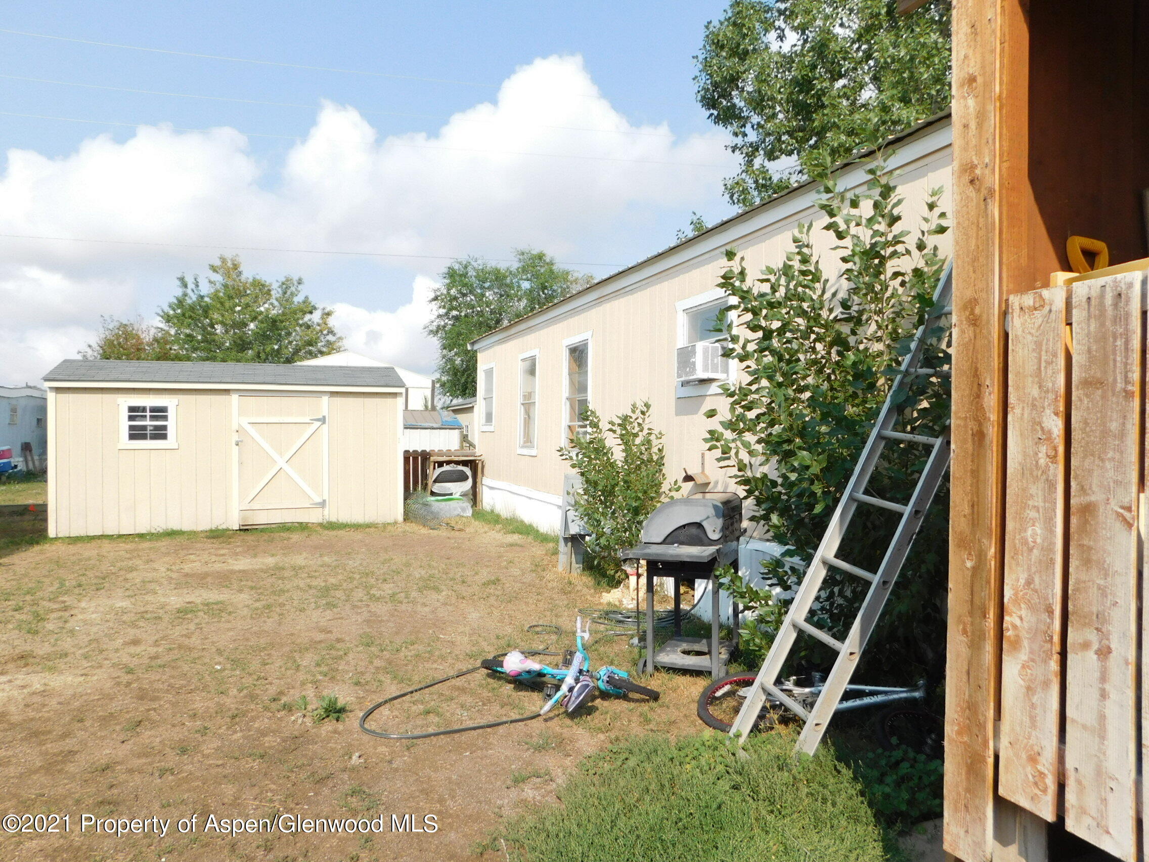 2210 West 3rd Street, Unit 28 Craig, CO 81625 - Photo 2 of 12 a backyard of a house with table and chairs