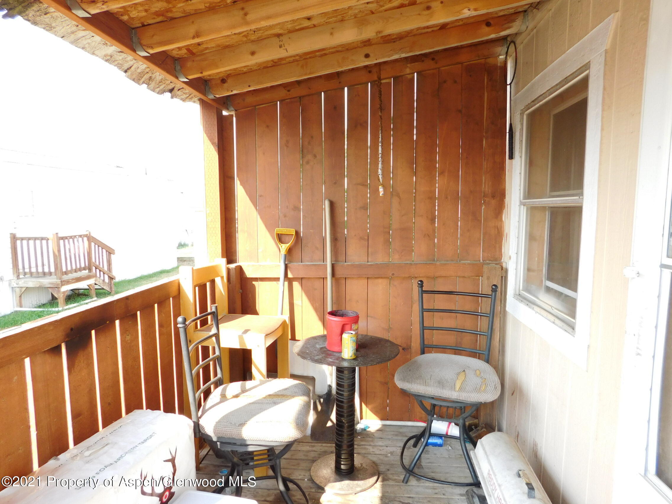 2210 West 3rd Street, Unit 28 Craig, CO 81625 - Photo 3 of 12 a balcony with table and chairs