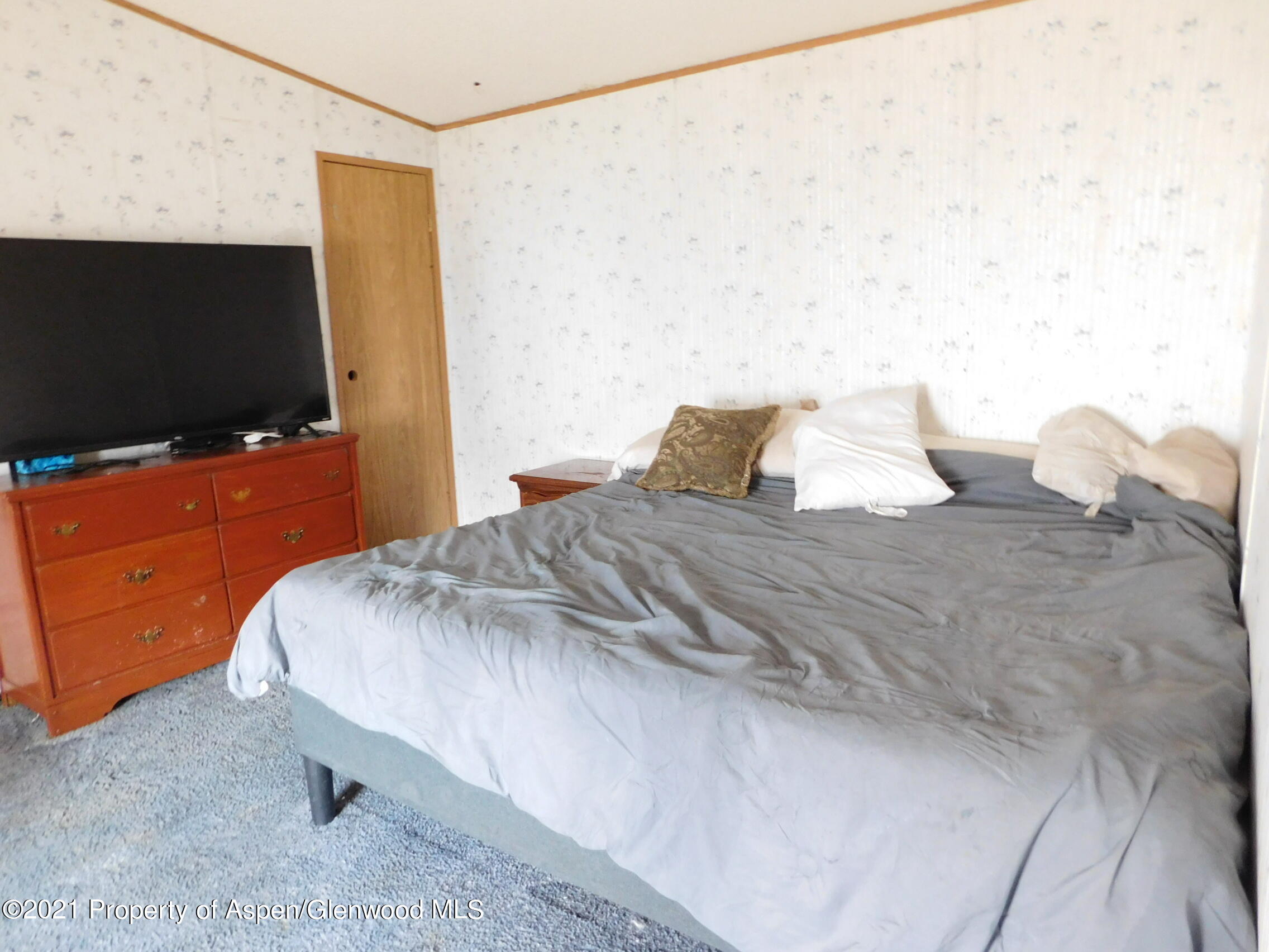 2210 West 3rd Street, Unit 28 Craig, CO 81625 - Photo 6 of 12 a bedroom with a bed and flat screen tv