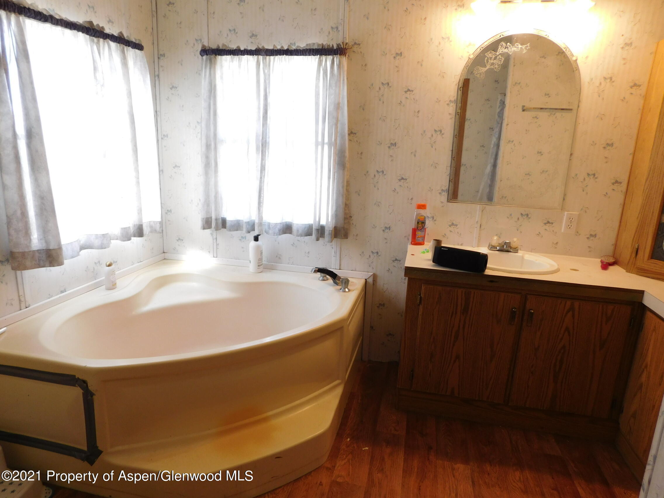 2210 West 3rd Street, Unit 28 Craig, CO 81625 - Photo 7 of 12 a bathroom with a tub sink and mirror