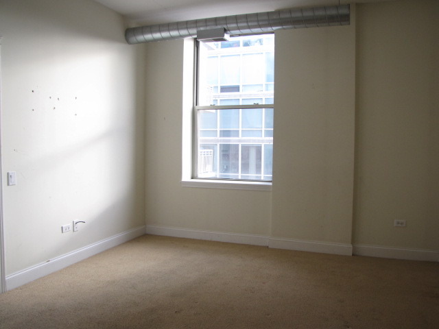 1001 West Madison Street, Unit 501 Chicago, IL 60607 - Photo 13 of 15 an empty room with a window