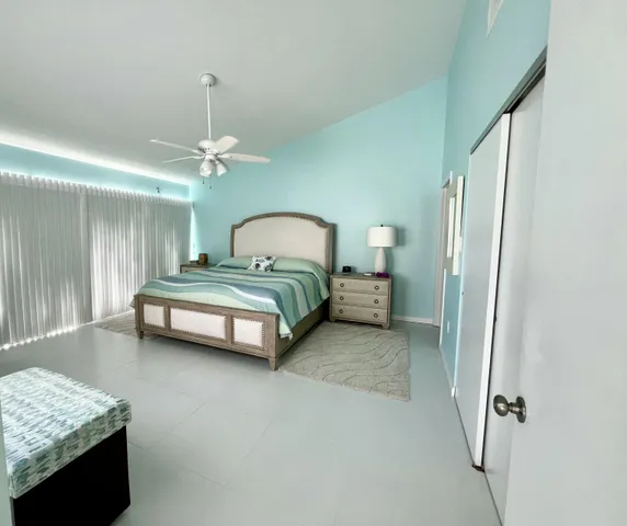 a spacious bedroom with a bed and a chandelier