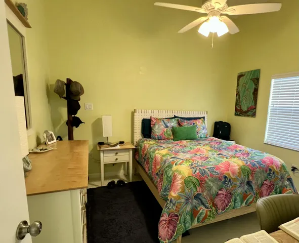 a bedroom with two beds and painting on the wall