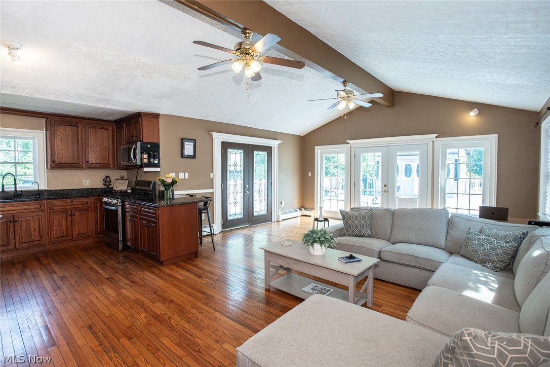 7075 Valley View Road Hudson, OH 44236 - Photo 6 of 17 Living room featuring hardwood flooring, ceiling fan, vaulted ceiling with beams, sink, and french doors