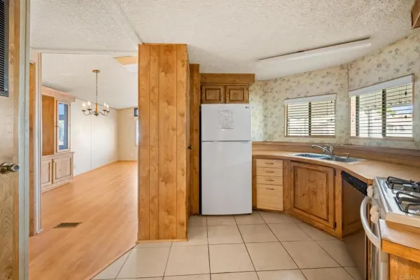 a kitchen with a refrigerator a sink and a stove top oven
