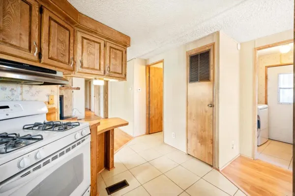 a kitchen with stainless steel appliances granite countertop a stove and a refrigerator